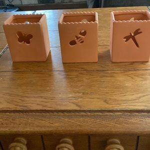New candle holders. Never used.  $9 for all 3. Terracotta